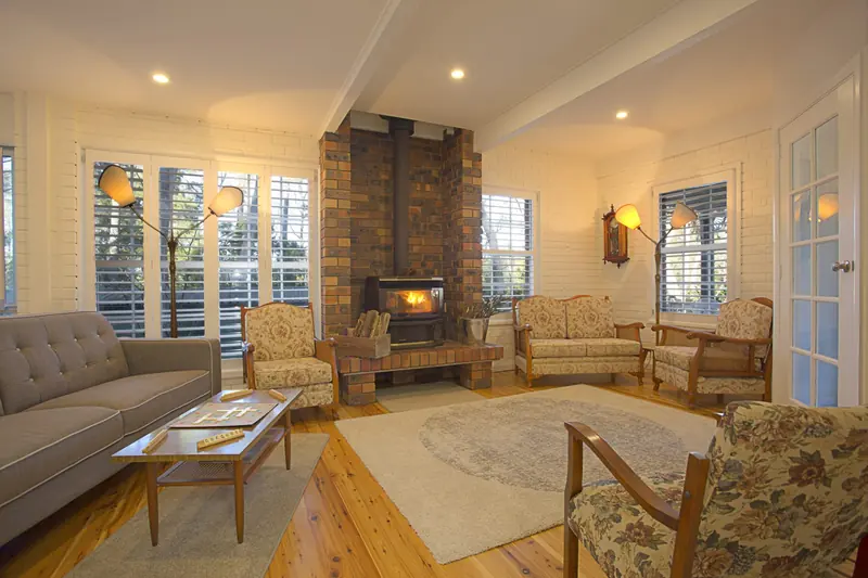 Relax by the wood-burning fireplace in the living room