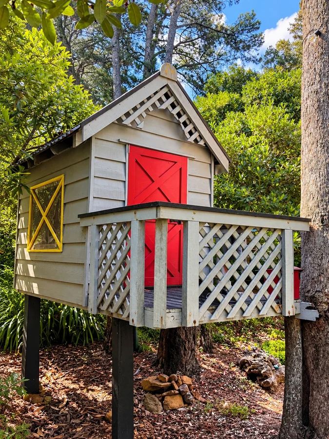 The colourful treehouse nestled among the trees — for looking, not climbing